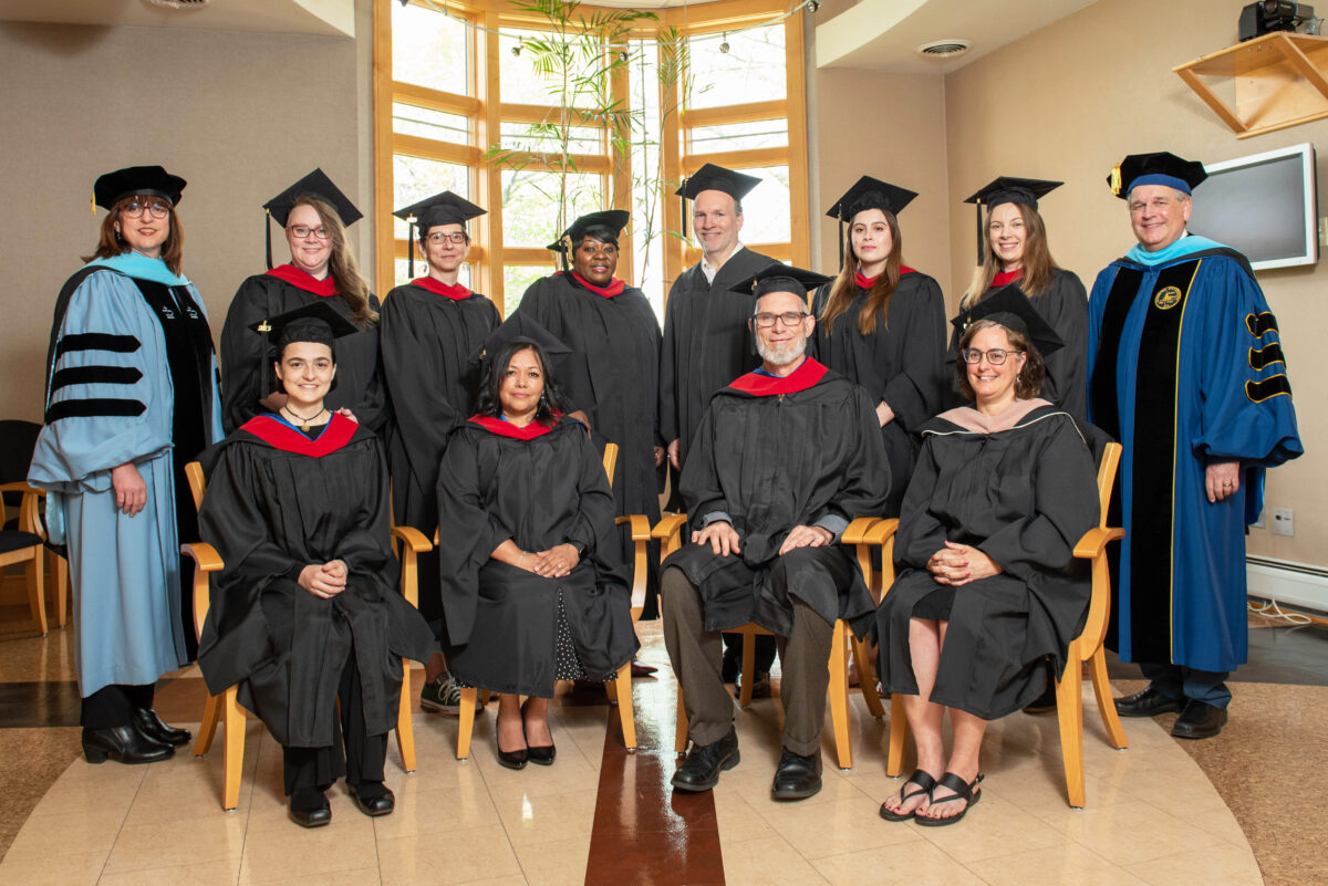 The 10 members of the Class of 2023 who were present for Anabaptist Mennonite Biblical Seminary’s April 29 Commencement Service pose with Beverly Lapp, EdD (at left), Vice President and Academic Dean, and David Boshart, PhD (at right), President. (Credit: Jason Bryant)