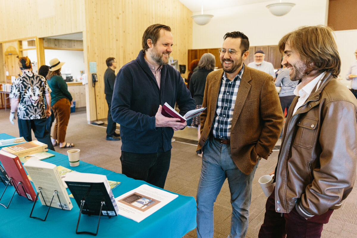 At the 41st annual Book Celebration at Anabaptist Mennonite Biblical Seminary on April 27, 2023, (l. to r.) Jamie Pitts, PhD, IMS Director, converses with David Cramer, PhD, IMS Managing Editor, and Isaiah Friesen, IMS Student Assistant. (Credit: Brittany Purlee)
