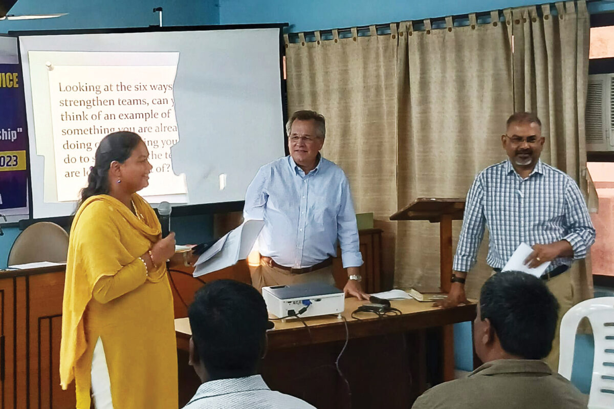 David Boshart (center) and Vikal Pravin Rao, Executive Secretary of the Mennonite Church in India (at right), look on while Sangita Tigga (at left) of Bihar Mennonite Mandli Conference reports during a leadership course in Kolkata, India, in October. (Credit: Andi Santoso/MMN)