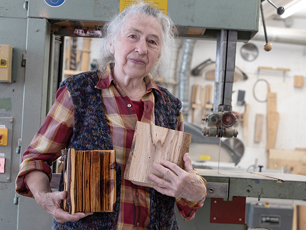 Artist Christine Langerhorst of Utrecht, Netherlands, holds two books that she carved from discarded wood. (Credit: Jan Bom)