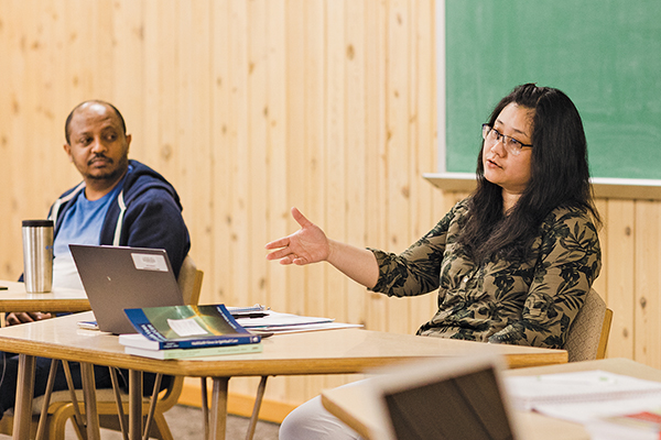 Chialis Thuan (at right) responds to a question during class as Dee Awoke of Ethiopia listens. (Credit: Brittany Purlee/AMBS)