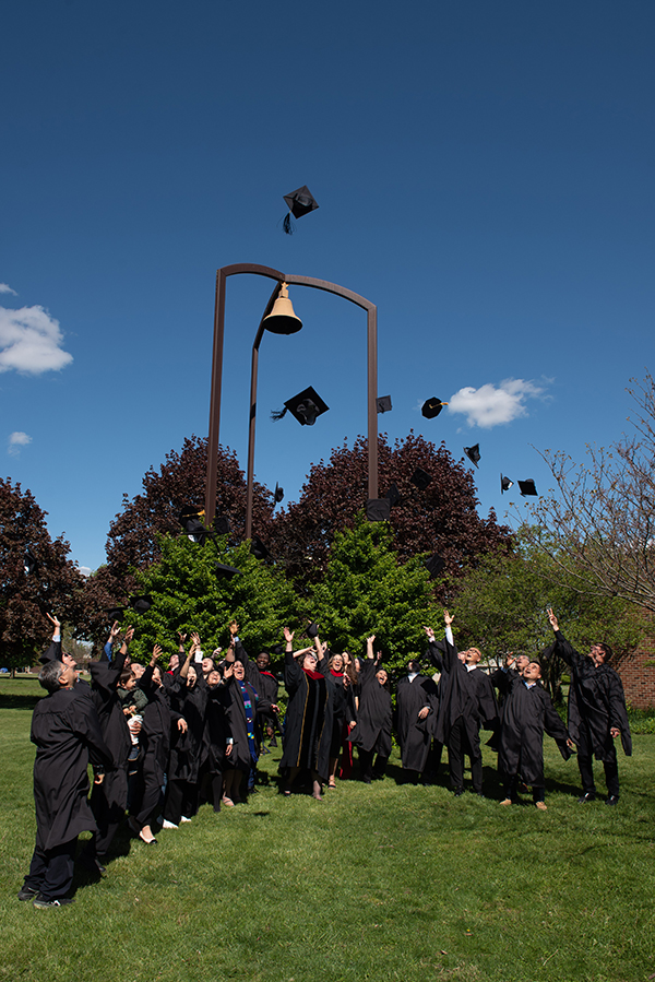 The members of the Class of 2026 and students who are part of a Korean-language master’s-degree cohort throw their caps into the air in celebration following Anabaptist Mennonite Biblical Seminary’s May 2 Commencement Service. (Credit: Jason Bryant/AMBS)