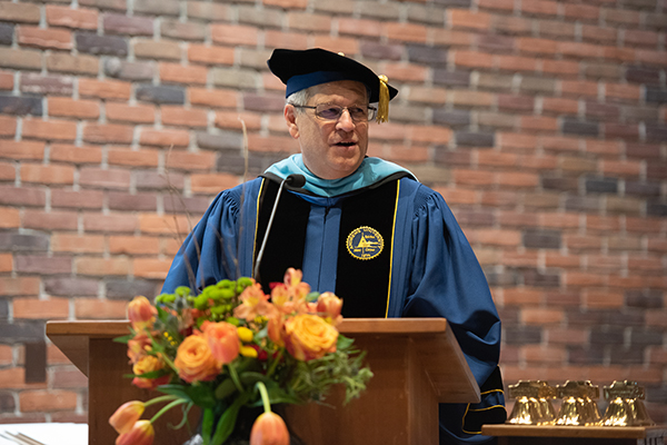 During Anabaptist Mennonite Biblical Seminary’s Commencement Service on May 2, 2026, David Boshart, PhD, President, welcomes the graduates, their guests and the seminary community. (Credit: Jason Bryant/AMBS)
